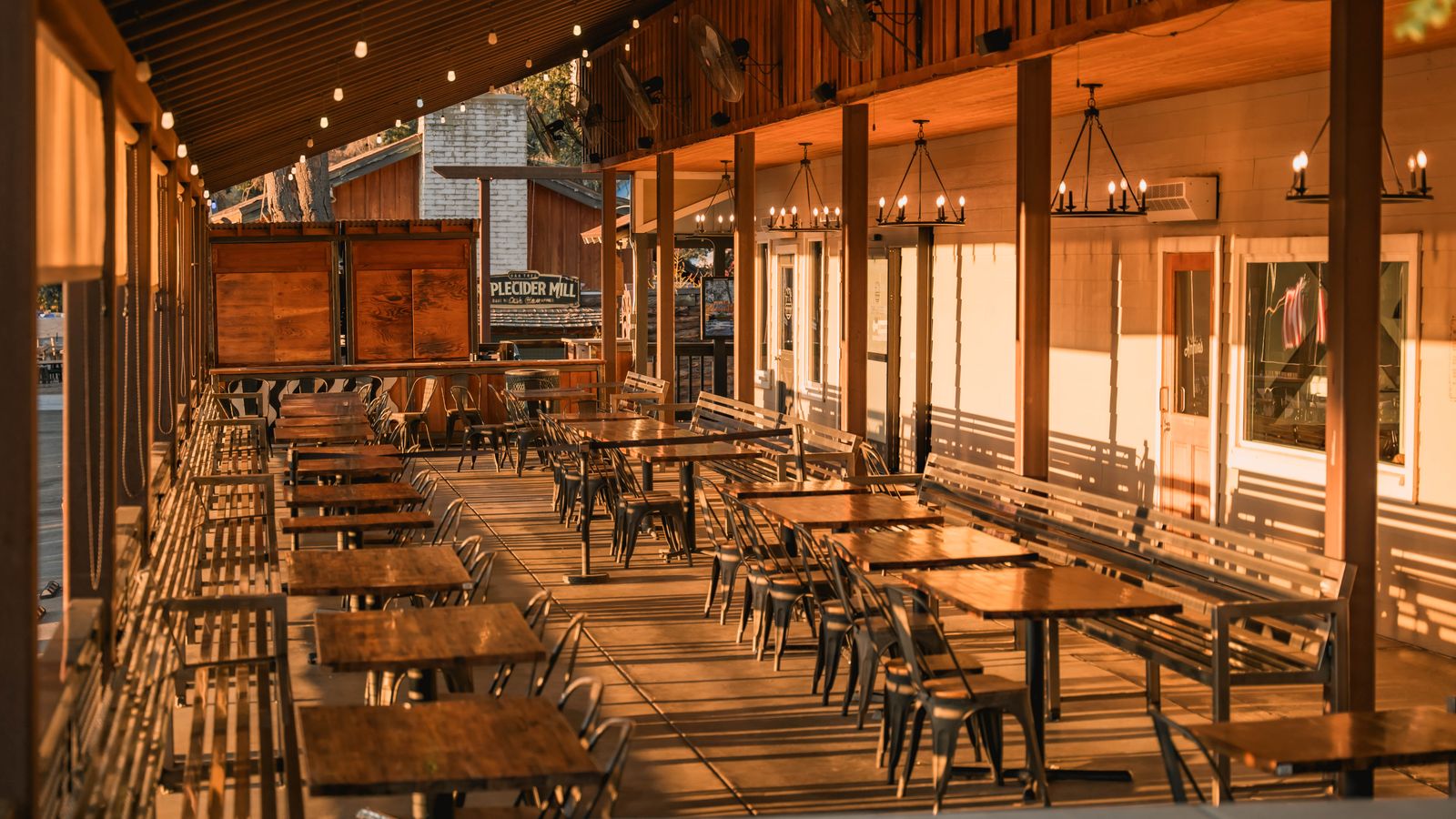 Restaurant patio with wooden tables in the evening